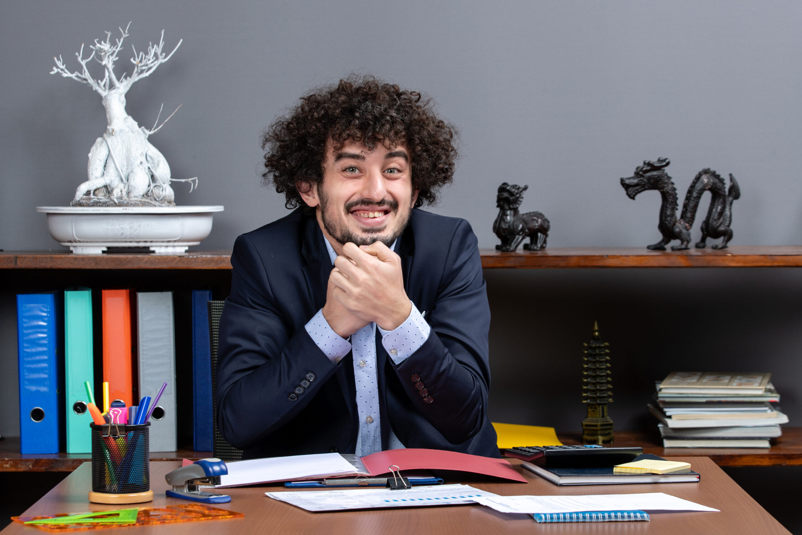 front-view-smiling-office-worker-sitting-desk-office